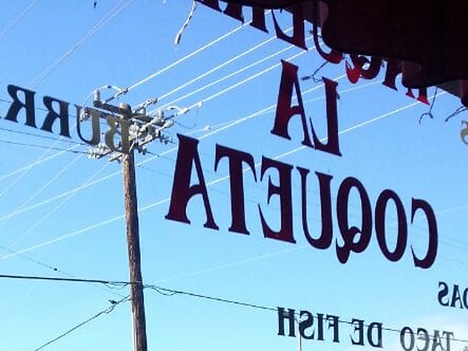 La Coqueta lettering on the window, read from inside