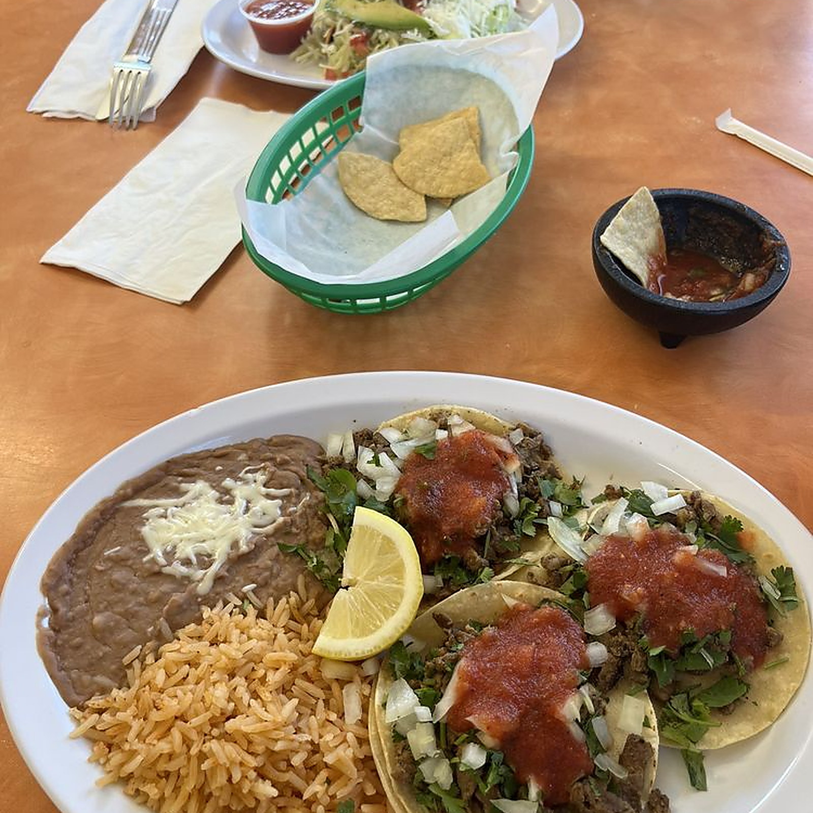 Three asada tacos, rice, beans, chips and salsa